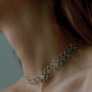 ngled view of Clover of Fortune necklace by joola – handcrafted in solid 18k gold with a high-polish finish and symbolic four-leaf clover design.